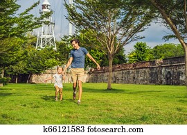 Dad and son on background of Fort Cornwallis in Georgetown, Penang, is a star fort built by the British East India Company in the late 18th century, it is the largest standing fort in Malaysia. Traveling with children concept