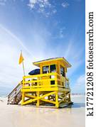 Siesta Key Beach, Florida USA, yellow colorful lifeguard house on a beautiful summer day with ocean and blue cloudy sky