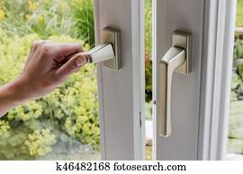 woman opens window for ventilation