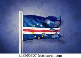 Torn flag of Cape Verde flying against grunge background