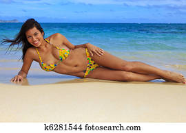 beautiful girl in a yellow bikini at the beach beautiful girl in a yellow bikini at the beach