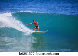 Young man surfing at Point Panic, Hawaii Young man surfing at Point Panic, Hawaii
