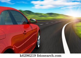 Red car driving by autobahn Red car driving by autobahn