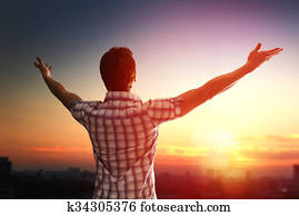 Successful man looking up to sky 