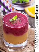 Two layered smoothie with peach and berries