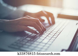 Working at home with laptop woman writing a blog. Female hands on the keyboard Working at home with laptop woman writing a blog. Female hands on the keyboard