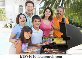 Family Enjoying A Barbeque Family Enjoying A Barbeque