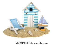Beach hut with sailing boat and chair