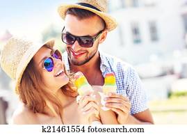 Lovely couple eating ice-cream in the city