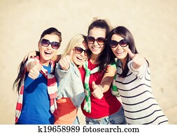 teenage girls or young women showing thumbs up