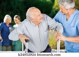 Male And Female Nurses Helping Senior People Male And Female Nurses Helping Senior People