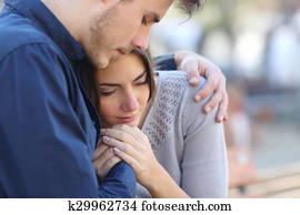 Man comforting his sad mourning friend Man comforting his sad mourning friend