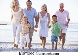 Extended family walking on beach