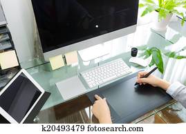 Business woman graphic designer working in office using tablet Business woman graphic designer working in office using tablet
