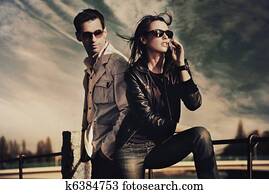 Attractive young couple wearing sunglasses