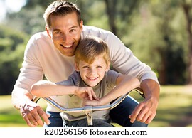 happy father and son on a bike happy father and son on a bike