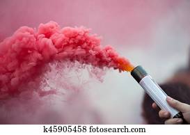 smoke bomb in human hand