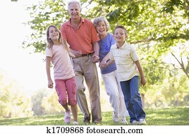 Grandparents walking with grandchildren. Grandparents walking with grandchildren.