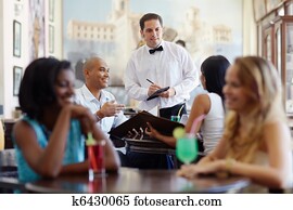 people ordering meal to waiter in restaurant people ordering meal to waiter in restaurant