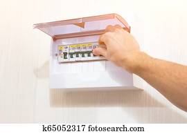 Hand switches to turn on. Switchboard of an electrical circuit panel.