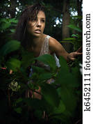 Delicate brunette posing in a forest