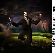 man chained to ground with storm in background man chained to ground with storm in background