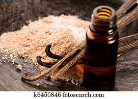 Vanilla With Bottle Of Essential Oil And Powder- Beauty Treatment Vanilla With Bottle Of Essential Oil And Powder- Beauty Treatment