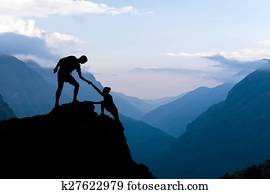 Teamwork couple climbing helping hand Teamwork couple climbing helping hand