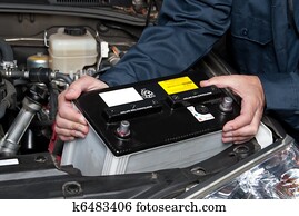 Auto mechanic replacing car battery Auto mechanic replacing car battery