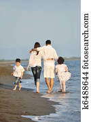 happy young family have fun on beach at sunset happy young family have fun on beach at sunset