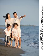 happy young family have fun on beach at sunset