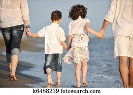 happy young family have fun on beach at sunset happy young family have fun on beach at sunset