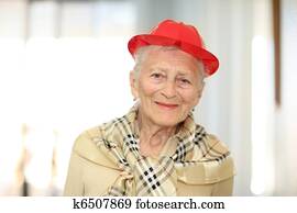 Happy elderly woman in red hat Happy elderly woman in red hat