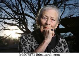 Portrait of a senior woman outdoors, thinking
