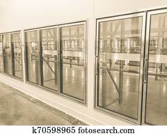 Vintage tone row of empty commercial fridges at wholesale big-box store Vintage tone row of empty commercial fridges at wholesale big-box store