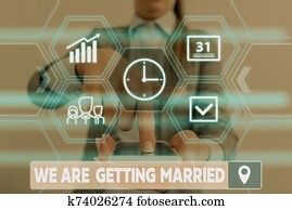 Conceptual hand writing showing We Are Getting Married. Business photo showcasing Engagement Wedding preparation Loving couple Woman wear work suit presenting presentation smart device. Conceptual hand writing showing We Are Getting Married. Business photo showcasing Engagement Wedding preparation Loving couple Woman wear work suit presenting presentation smart device.