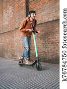 Young man driving electric scooter. Young man driving electric scooter.