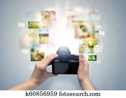 Hand captures life events with digital camera
