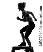 woman exercising step aerobics woman exercising step aerobics