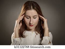 Woman with closed eyes tilting head back, studio shot Stock Photograph