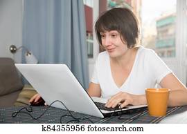 Woman surfing in Internet using laptop Woman surfing in Internet using laptop