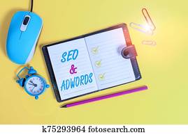 Word writing text Seo And Adwords. Business concept for Pay per click Digital marketing Google Adsense Locked diary sheets clips marker mouse alarm clock colored background. Word writing text Seo And Adwords. Business concept for Pay per click Digital marketing Google Adsense Locked diary sheets clips marker mouse alarm clock colored background.