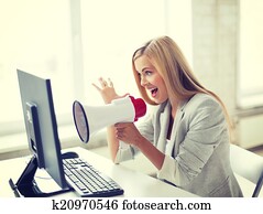 crazy businesswoman shouting in megaphone