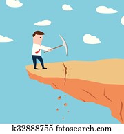 Man on a cliff edge digging ground Man on a cliff edge digging ground