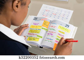 Businesswoman Writing Schedule In Diary Businesswoman Writing Schedule In Diary