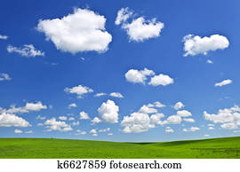 Green rolling hills under blue sky