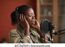 Talented African-American Woman Singing in Recording Studio
