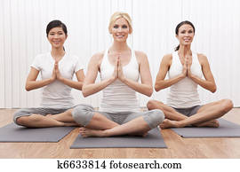 Interracial Group of Three Beautiful Women In Yoga Position