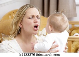 Stressed Mother Holding Baby In Nursery Stressed Mother Holding Baby In Nursery