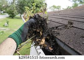 Worker Cleaning Gutters For A Customer Worker Cleaning Gutters For A Customer